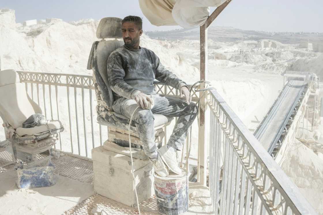 Everything at the quarry, workers included, is coated in a film of white dust Everything at the quarry, workers included, is coated in a film of white dust