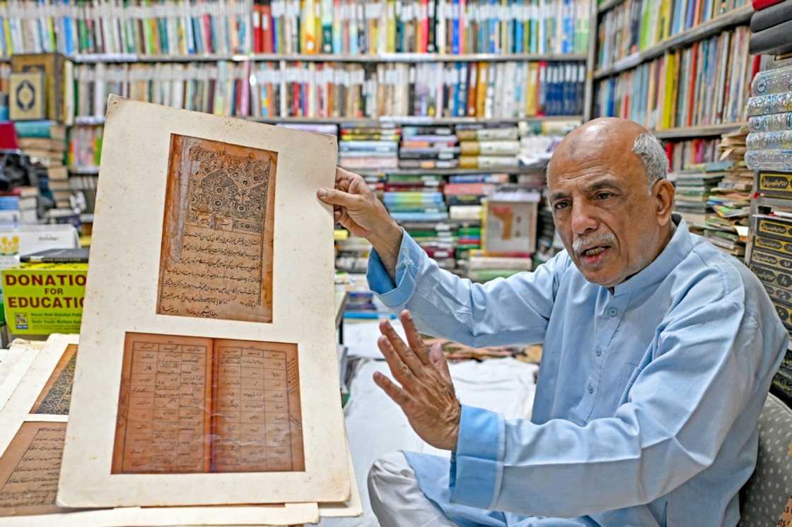 Sikander Mirza Changzi, co-founder of Hazrat Shah Waliullah, publicly displays several pages of old Urdu literature.