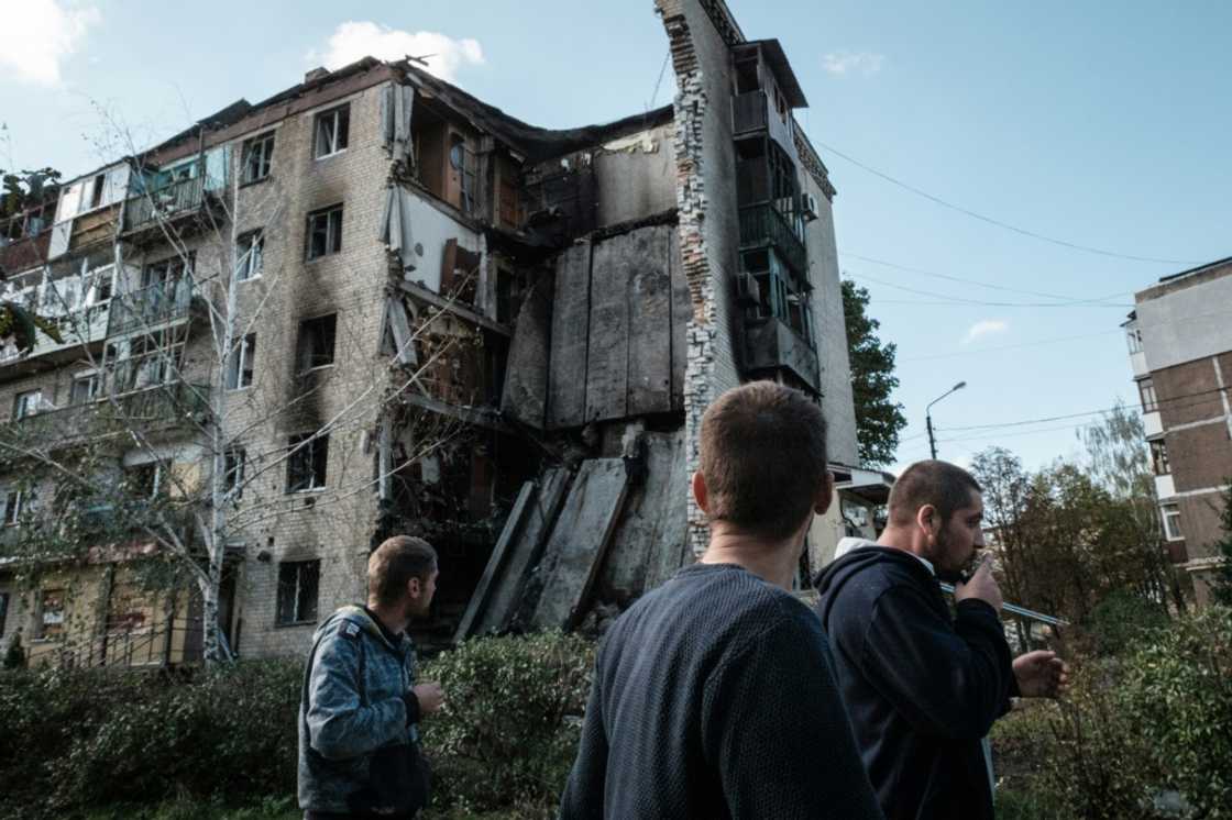 Residents of Bakhmut walk past destroyed residential buildings, with Russian forces advancing Residents of Bakhmut walk past destroyed residential buildings, with Russian forces advancing