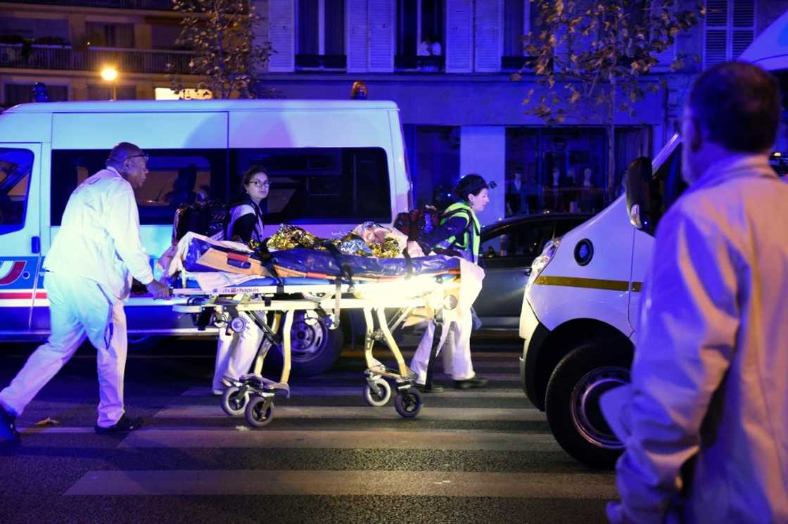Rescuers evacuate a victim close to the Bataclan following the attack on November 13, 2015 Rescuers evacuate a victim close to the Bataclan following the attack on November 13, 2015
