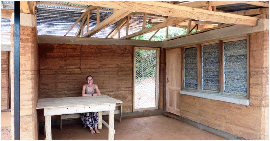 A woman sits inside the Nkabom House