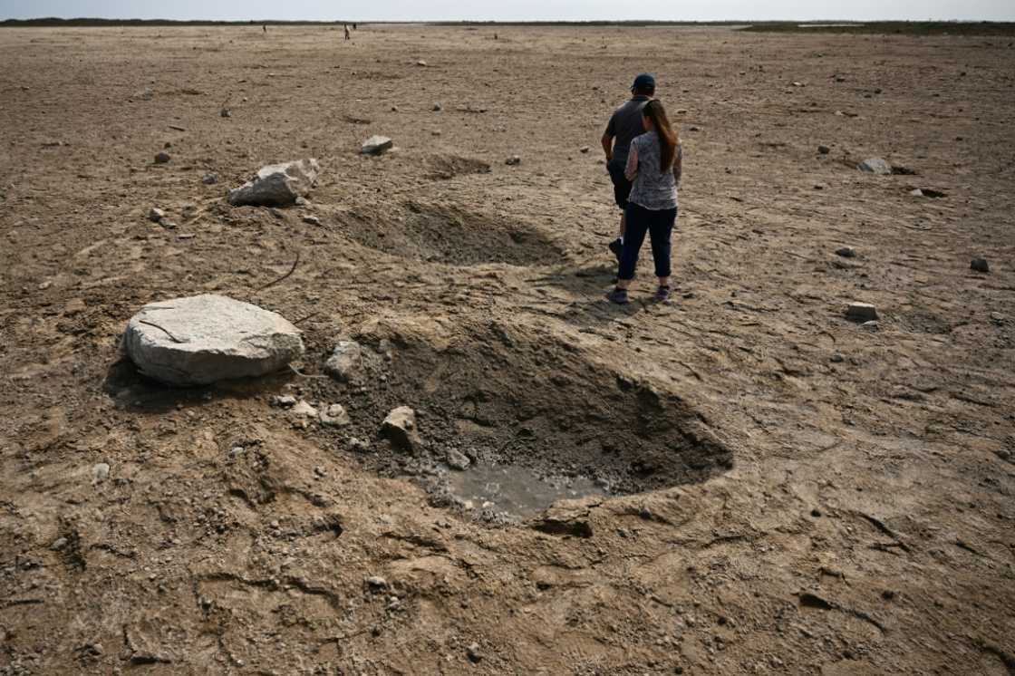 Members of the public walk through a debris field near the SpaceX launch pad on April 22, 2023 Members of the public walk through a debris field near the SpaceX launch pad on April 22, 2023