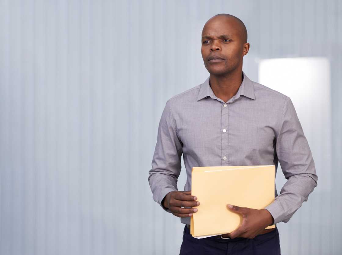 A man holding a folder A man holding a folder