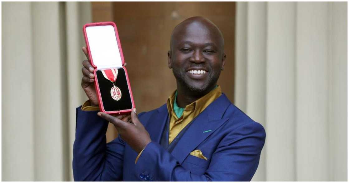 David Adjaye shows off the medal received after being Knighted David Adjaye shows off the medal received after being Knighted