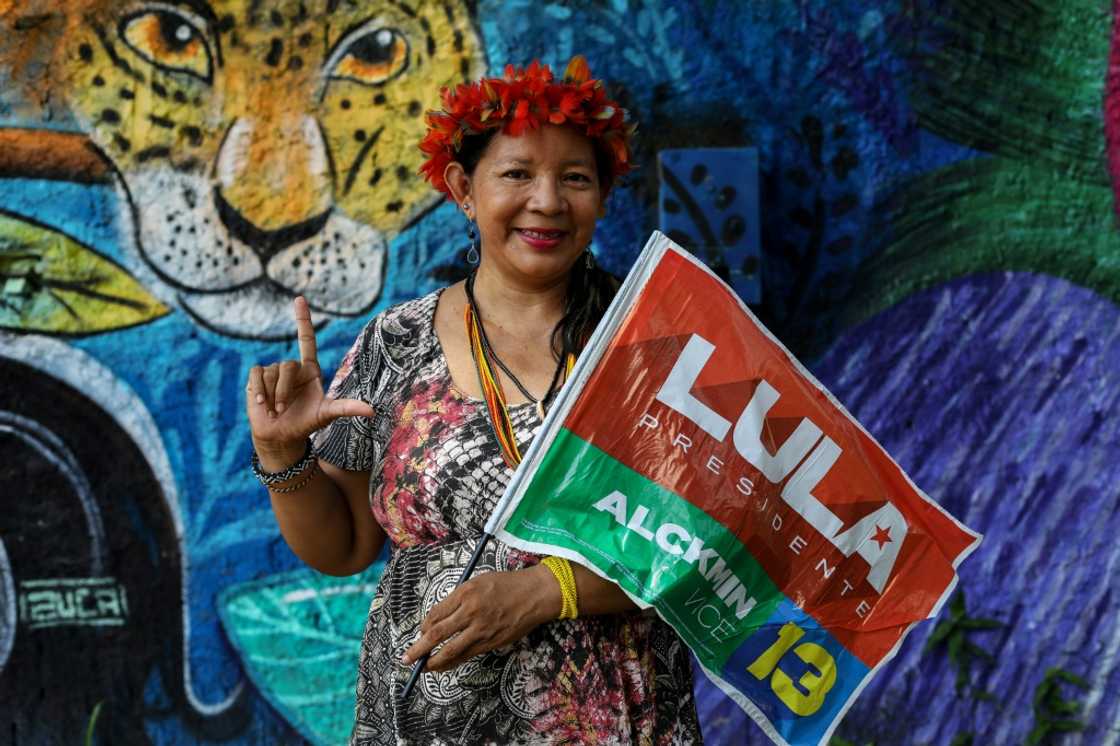 Claudia Bare, an indigenous woman from the Bare tribe, holds a flag in support of Brazil's former president Luiz Inacio Lula da Silva, who is running to hold the office again