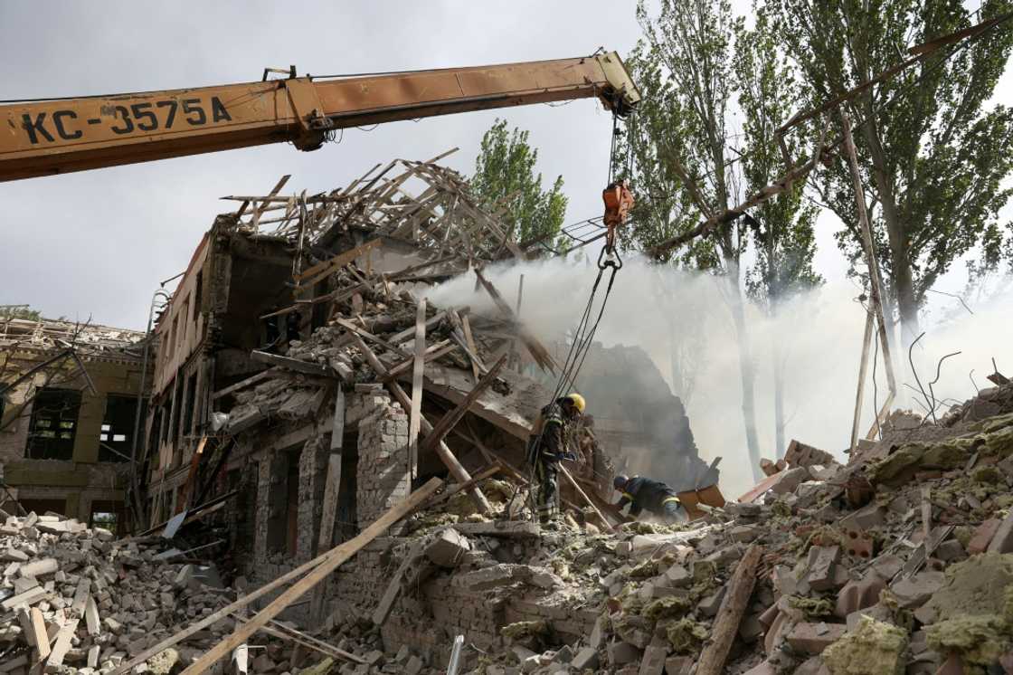 Ukrainian rescuers use a crane to move the debris out of a school building Kramatorsk Ukrainian rescuers use a crane to move the debris out of a school building Kramatorsk