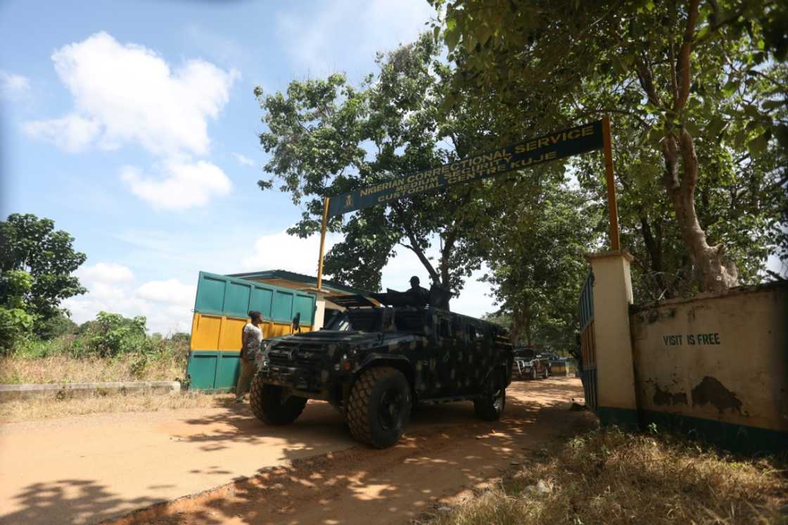 On guard at the outside gate of Nigeria's Kuje prison after suspected Boko Haram gunmen attacked the facility On guard at the outside gate of Nigeria's Kuje prison after suspected Boko Haram gunmen attacked the facility