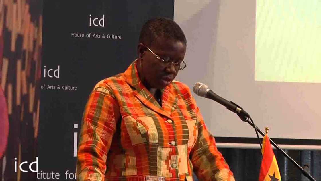 A woman facing a microphone A woman facing a microphone