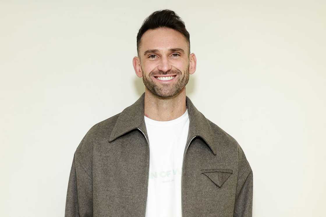 Carl Radke in a white tee and grey jacket