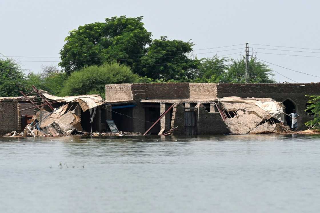 A man stands amid the ruins of a flooded hamlet in Dadu district, Sindh province A man stands amid the ruins of a flooded hamlet in Dadu district, Sindh province