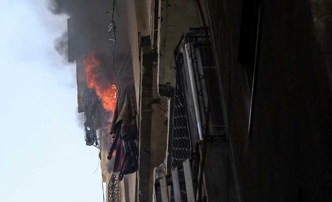 Flames pour out of a blazing building in Gaza City following an Israeli air strike Flames pour out of a blazing building in Gaza City following an Israeli air strike