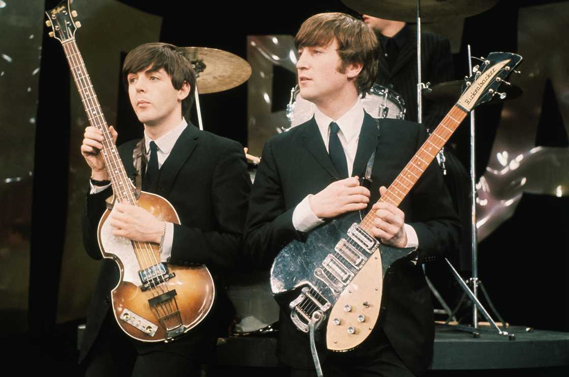 Paul McCartney (L) and John Lennon (R) perform on the set of 'The Ed Sullivan Show Paul McCartney (L) and John Lennon (R) perform on the set of 'The Ed Sullivan Show