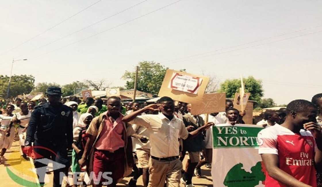 A group of people marching A group of people marching