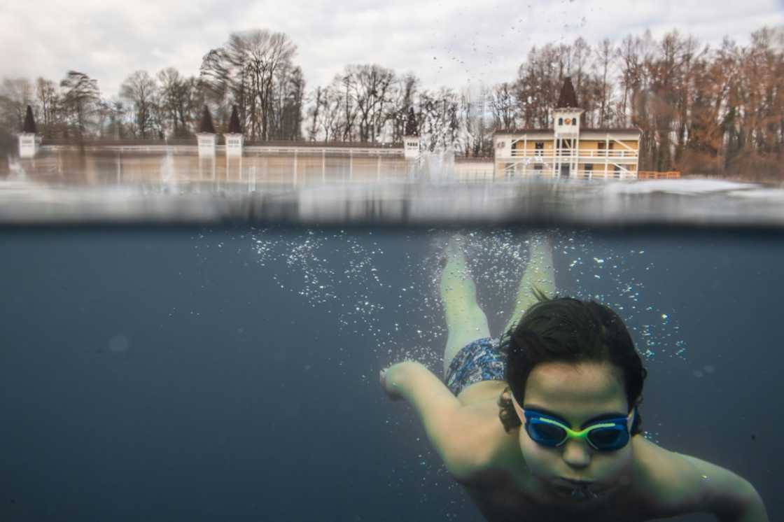A child swims in the hot thermal lake at Heviz, Hungary A child swims in the hot thermal lake at Heviz, Hungary