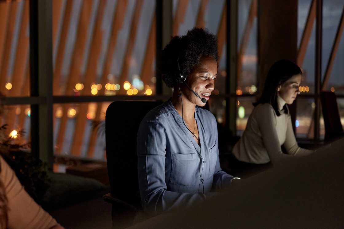 A Ghanaian call centre agent listens during a long late-night call.