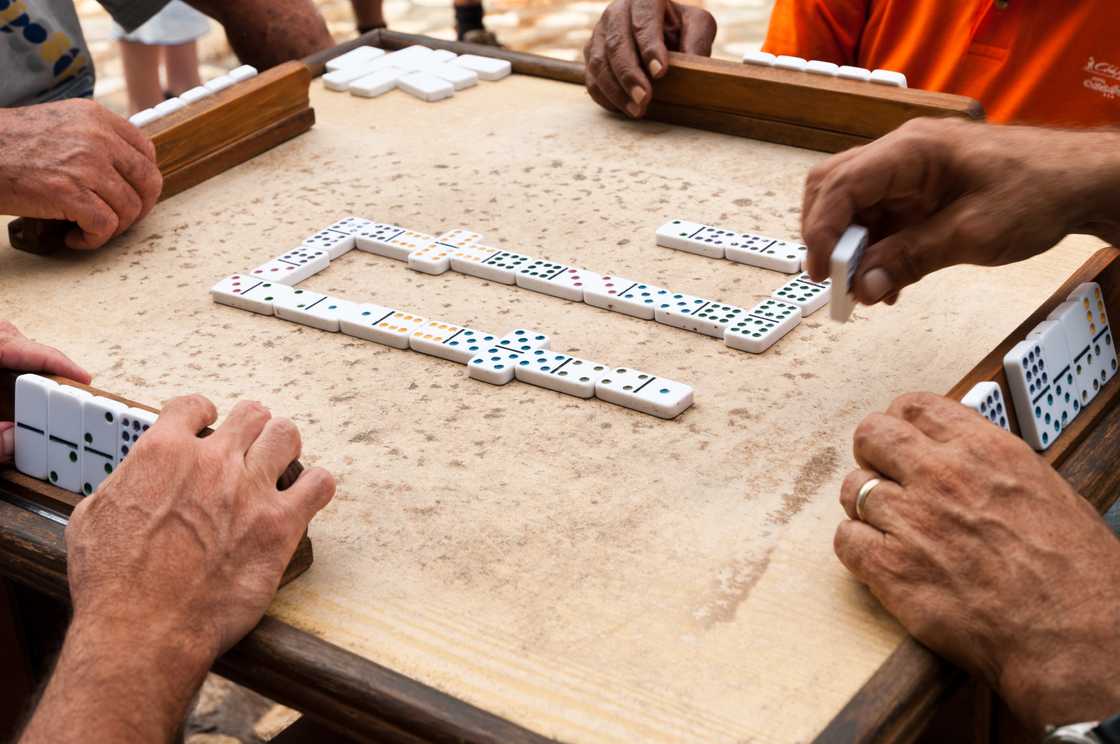 Cuban citizens are playing the dominoes game Cuban citizens are playing the dominoes game