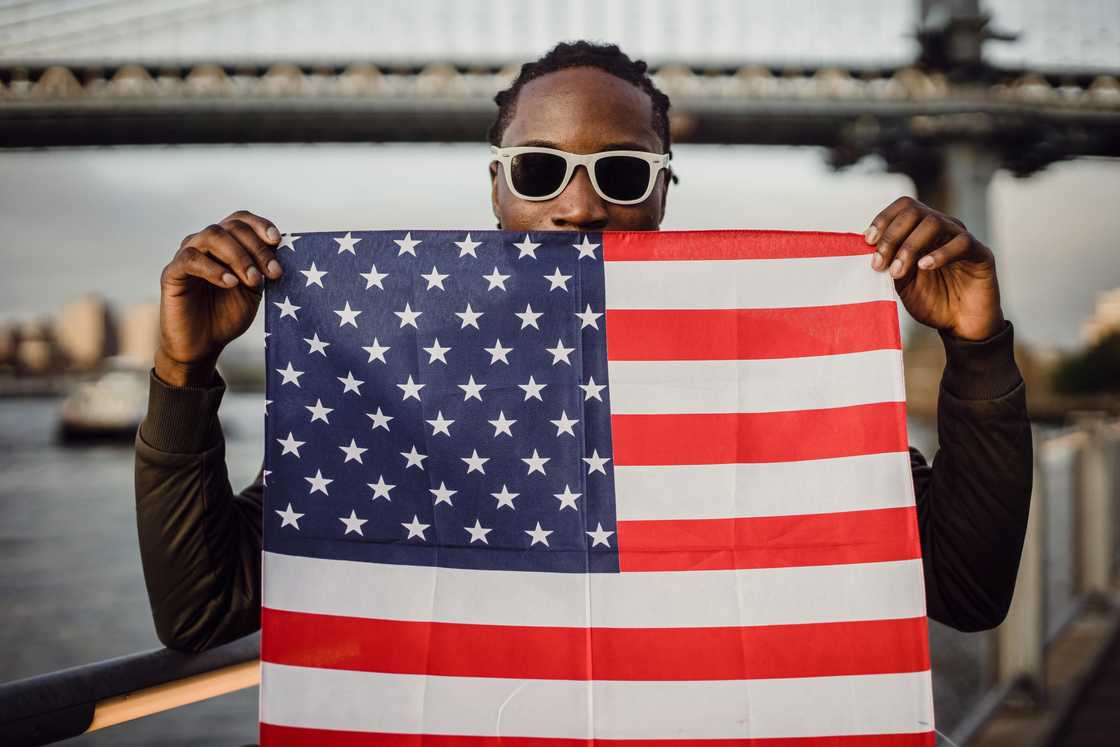 An African-American man with an American flag kerchief in his hands An African-American man with an American flag kerchief in his hands