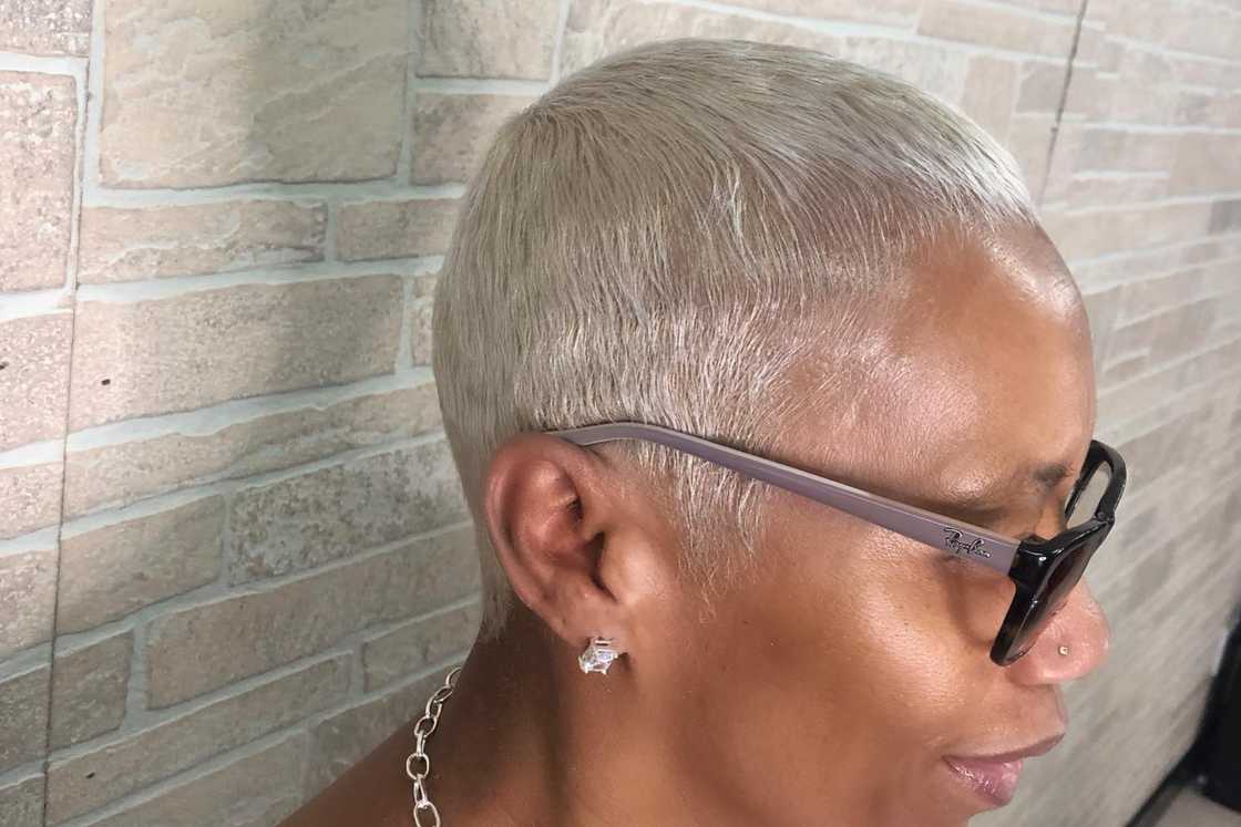 A woman is rocking a platinum blonde caesar cut