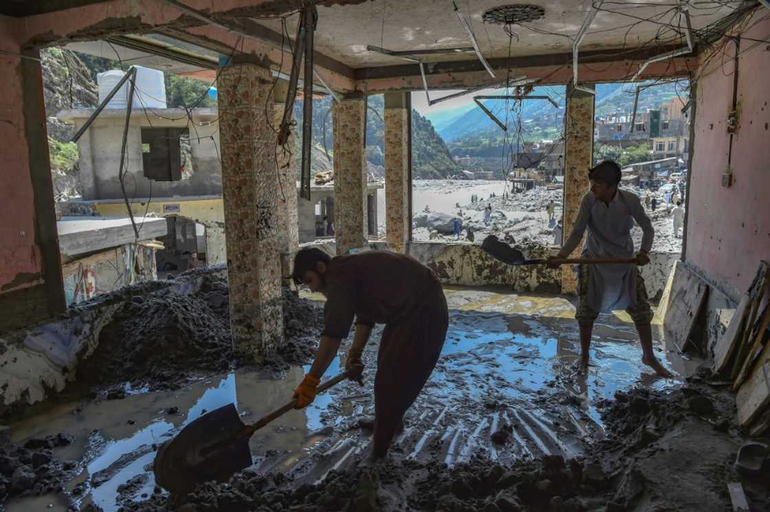 Workers clear sludge from a hotel badly damaged by flash floods of the Swat River near Bahrain in Khyber Pakhtunkhwa province Workers clear sludge from a hotel badly damaged by flash floods of the Swat River near Bahrain in Khyber Pakhtunkhwa province