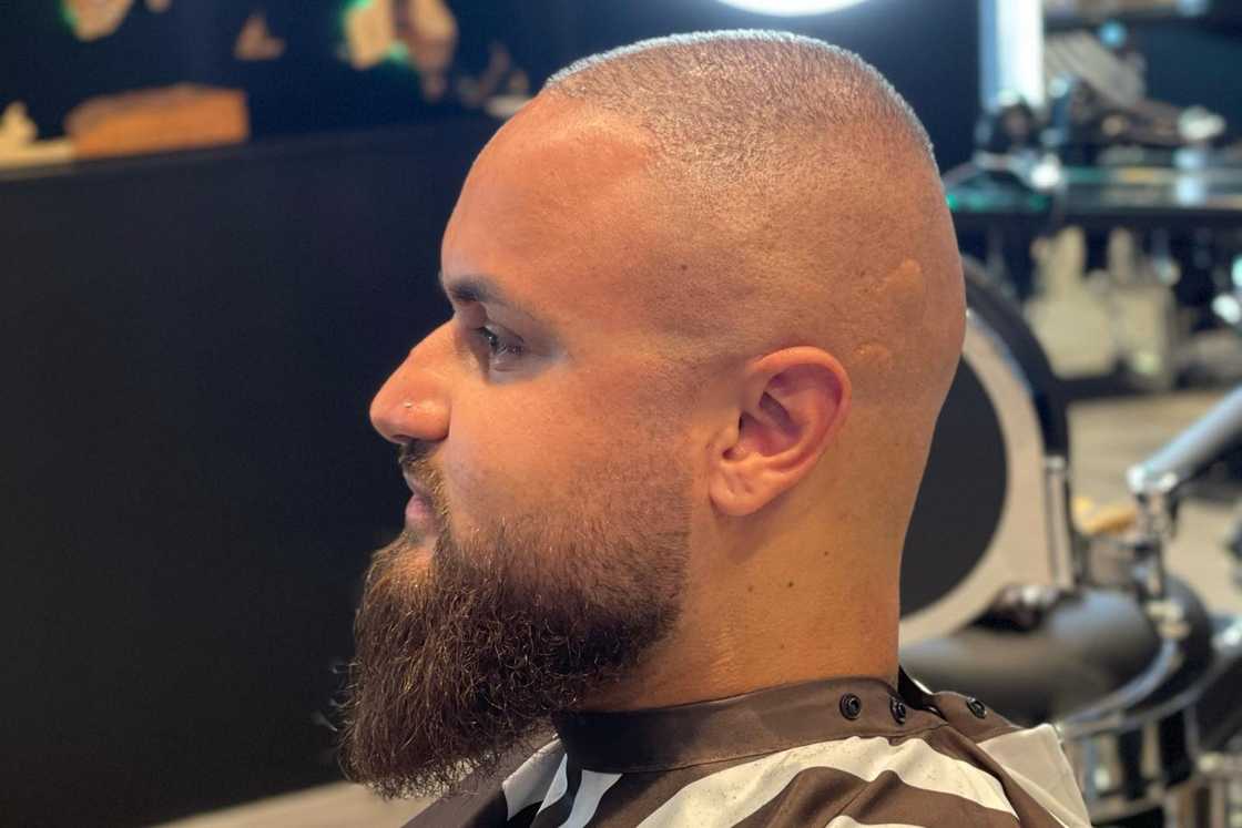 Closely shaved haircut with a skin fade beard