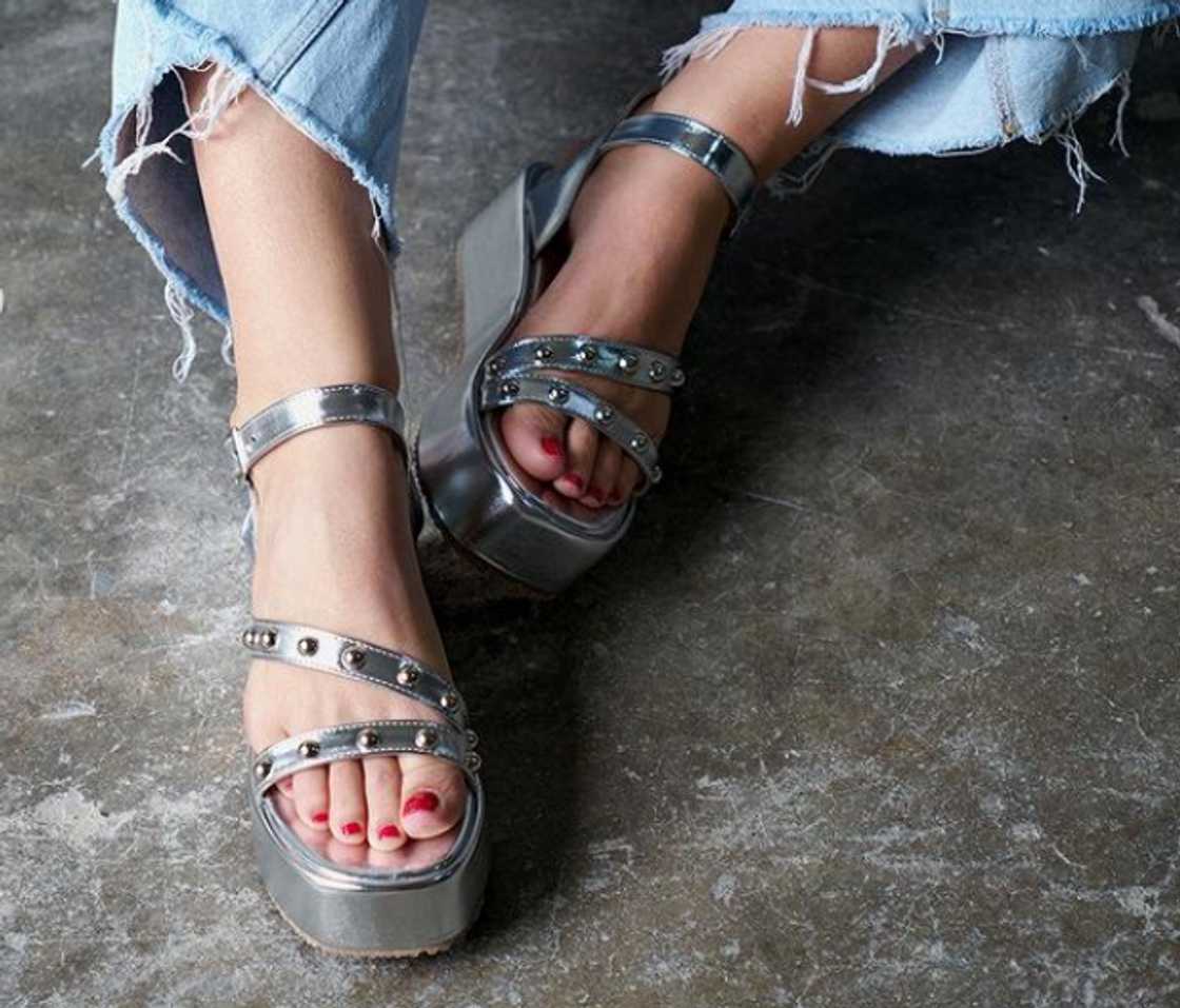 A woman wearing metallic platform sandals