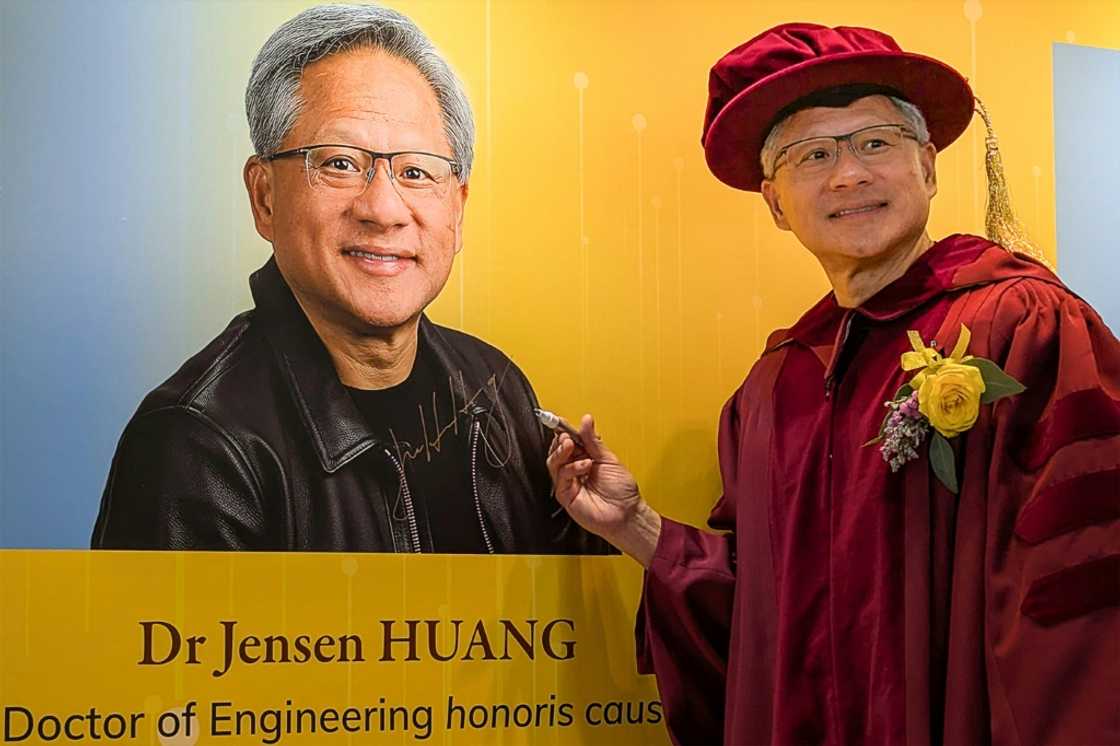 Nvidia CEO Jensen Huang poses for a photo after receiving an honorary doctorate in engineering from the Hong Kong University of Science and Technology