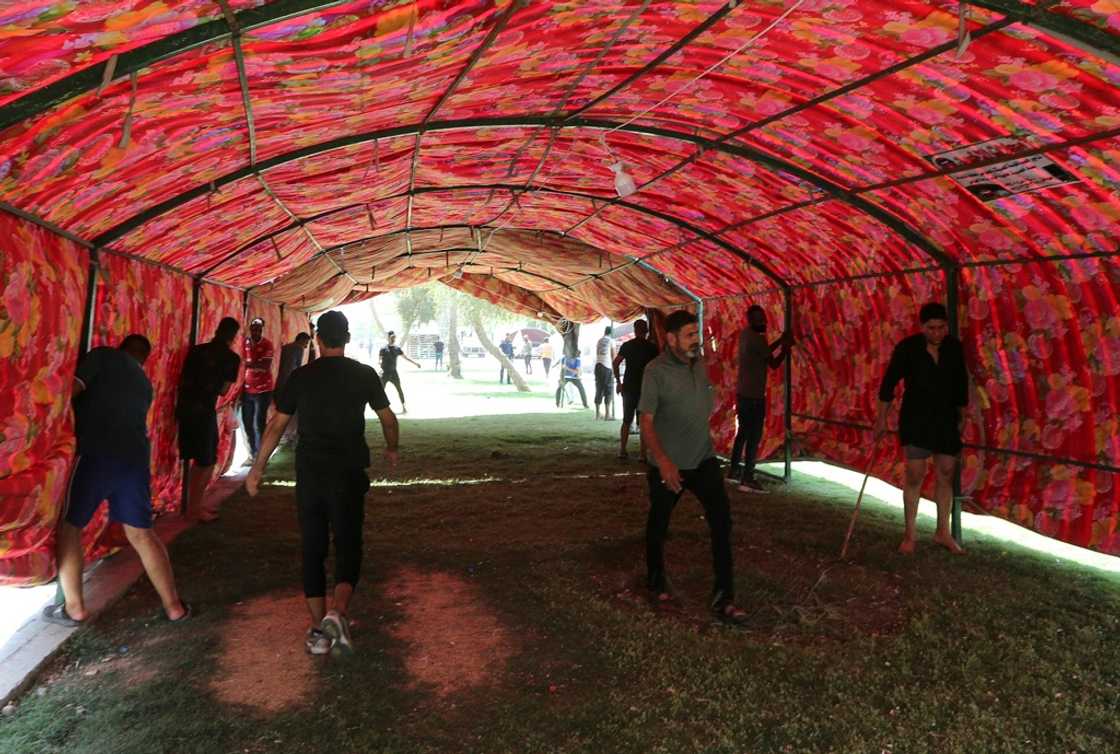 Supporters of Iraq's pro-Iran Coordination Framework set up a tent on a bridge leading to the capital Baghdad's Green Zone Supporters of Iraq's pro-Iran Coordination Framework set up a tent on a bridge leading to the capital Baghdad's Green Zone