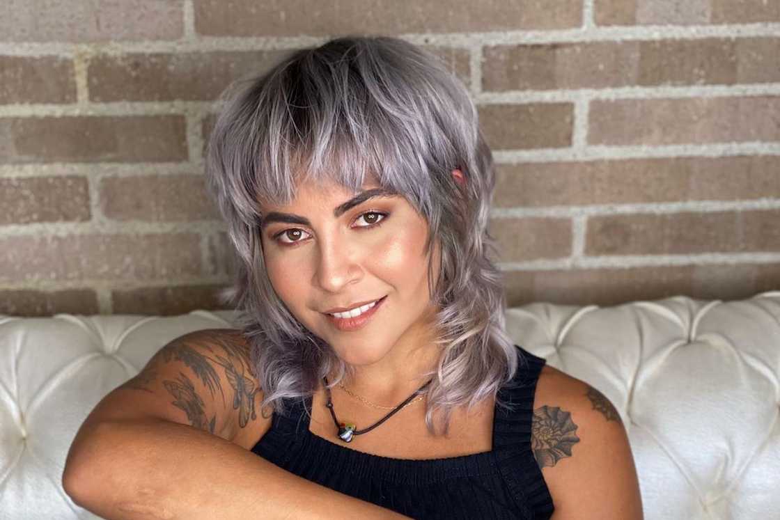 A white lady is wearing a straight pixie mullet style A white lady is wearing a straight pixie mullet style