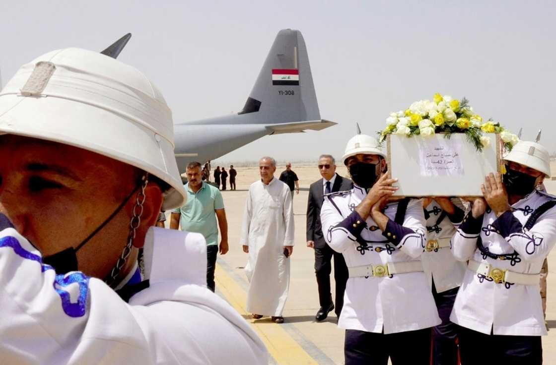 Honour guards at Baghdad airport carry caskets of the victims Honour guards at Baghdad airport carry caskets of the victims