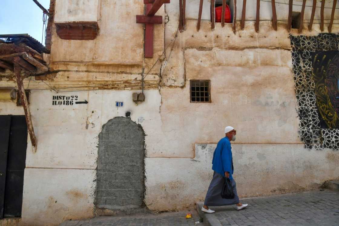 A man walks down a street in the historic Casbah of Algiers A man walks down a street in the historic Casbah of Algiers