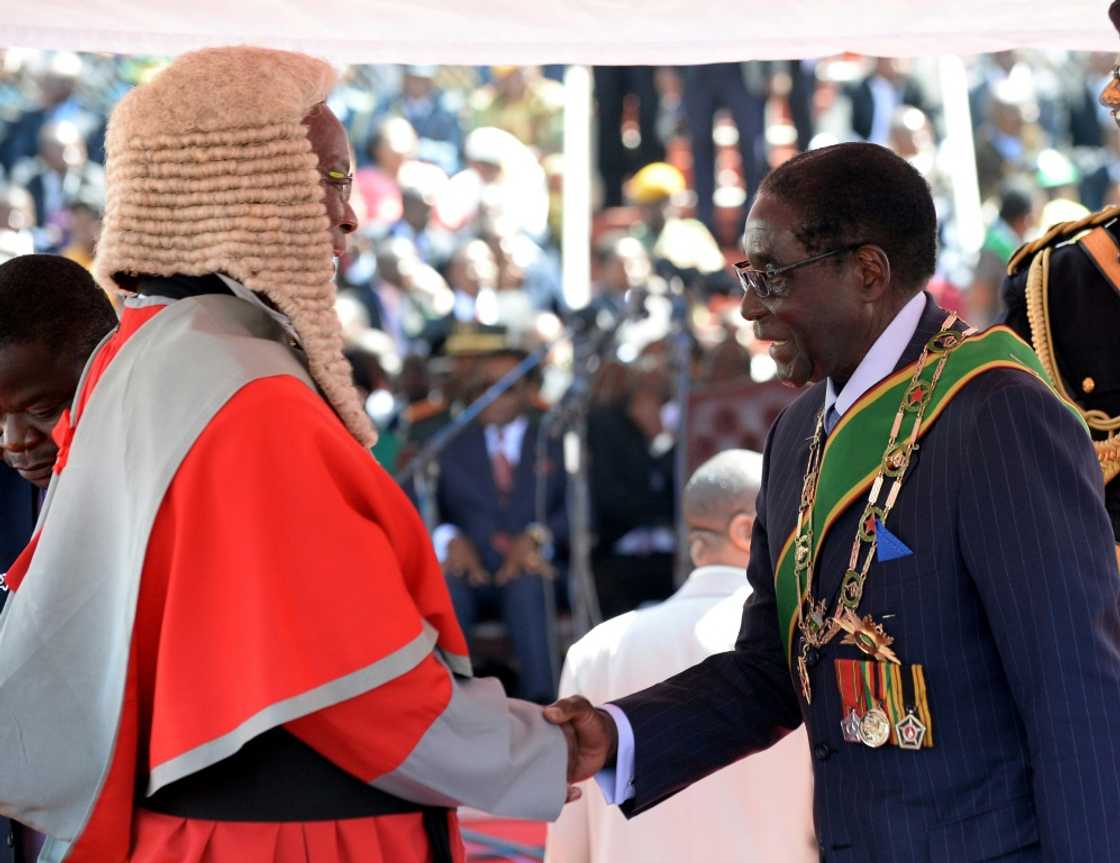 Britain's relations with Zimbabwe went downhill after Mugabe, seen here at a post-election inauguration ceremony in 2013, cracked down on dissent and seized land from white farmers Britain's relations with Zimbabwe went downhill after Mugabe, seen here at a post-election inauguration ceremony in 2013, cracked down on dissent and seized land from white farmers