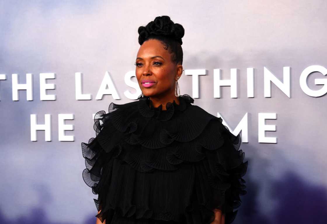 Aisha Tyler in a black ruffle dress as she attends a movie premier