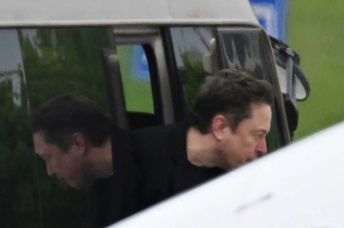 Tesla CEO Elon Musk gets off a minibus before boarding his private plane at Beijing airport Tesla CEO Elon Musk gets off a minibus before boarding his private plane at Beijing airport
