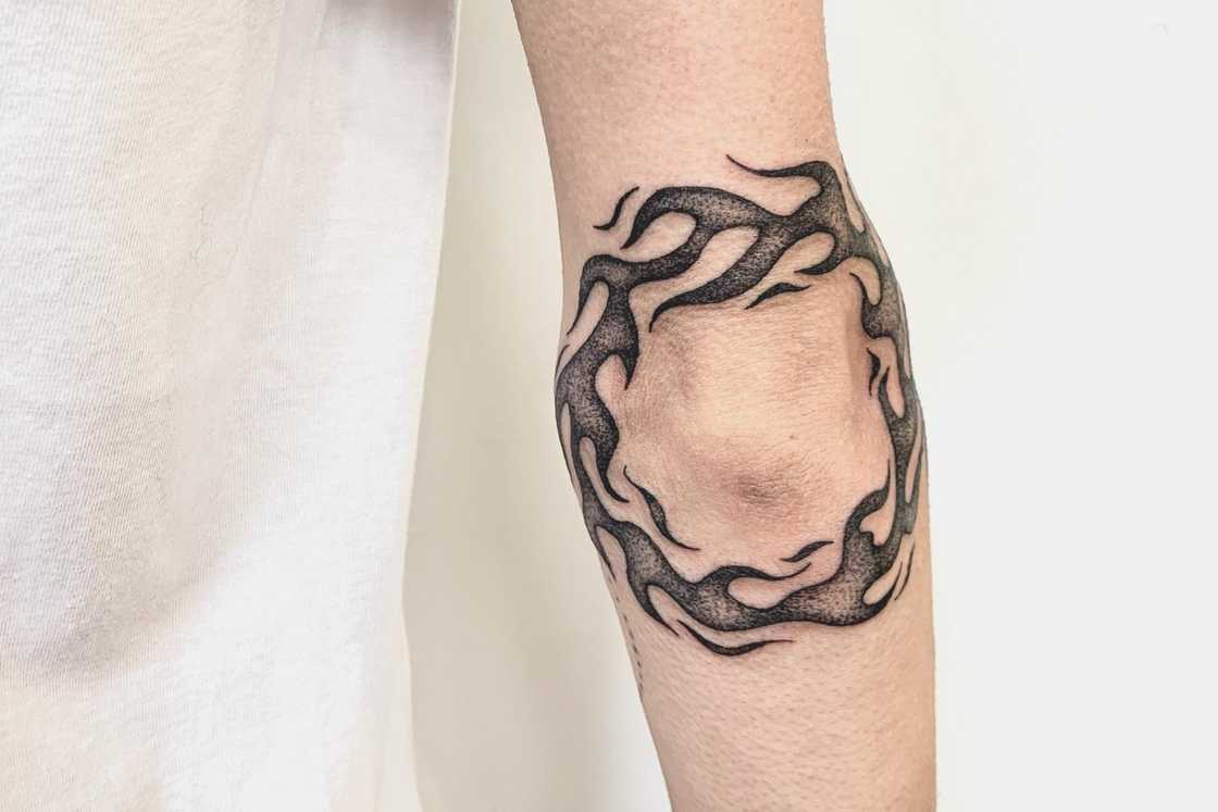 Black and grey freehand flames elbow tattoo Black and grey freehand flames elbow tattoo