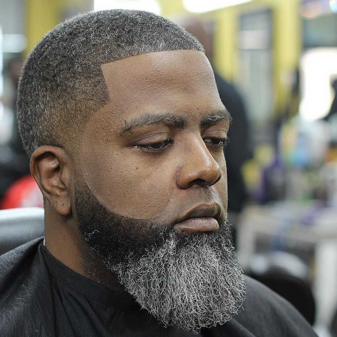 A black man with tapered beard fade