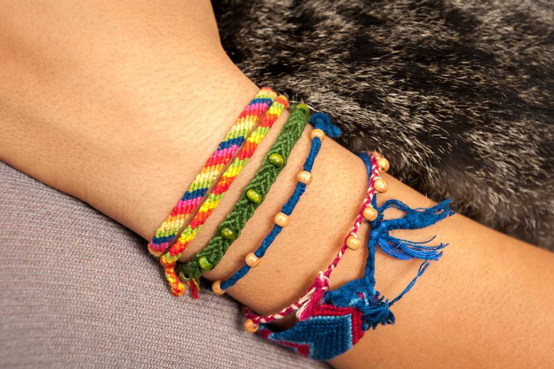 A lady wears several friendship bracelets on her wrist A lady wears several friendship bracelets on her wrist