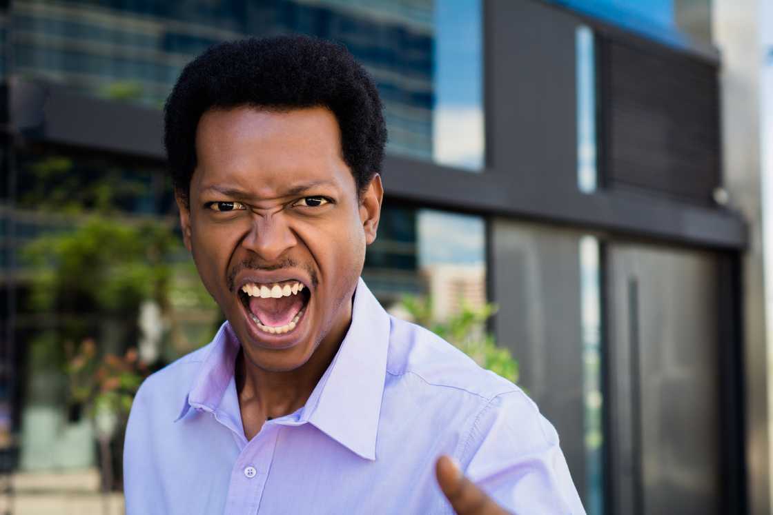 An angry man shouting to someone An angry man shouting to someone