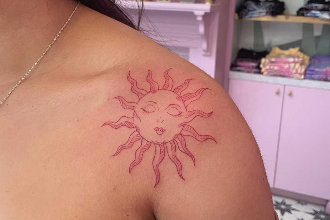 Sun shoulder tattoo featuring a woman's sleeping face Sun shoulder tattoo featuring a woman's sleeping face