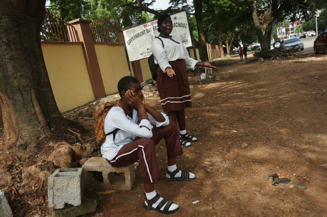 Students wait outside their Government Science Secondary School in the capital after unions launched an indefinite strike for a higher minimum wage Students wait outside their Government Science Secondary School in the capital after unions launched an indefinite strike for a higher minimum wage