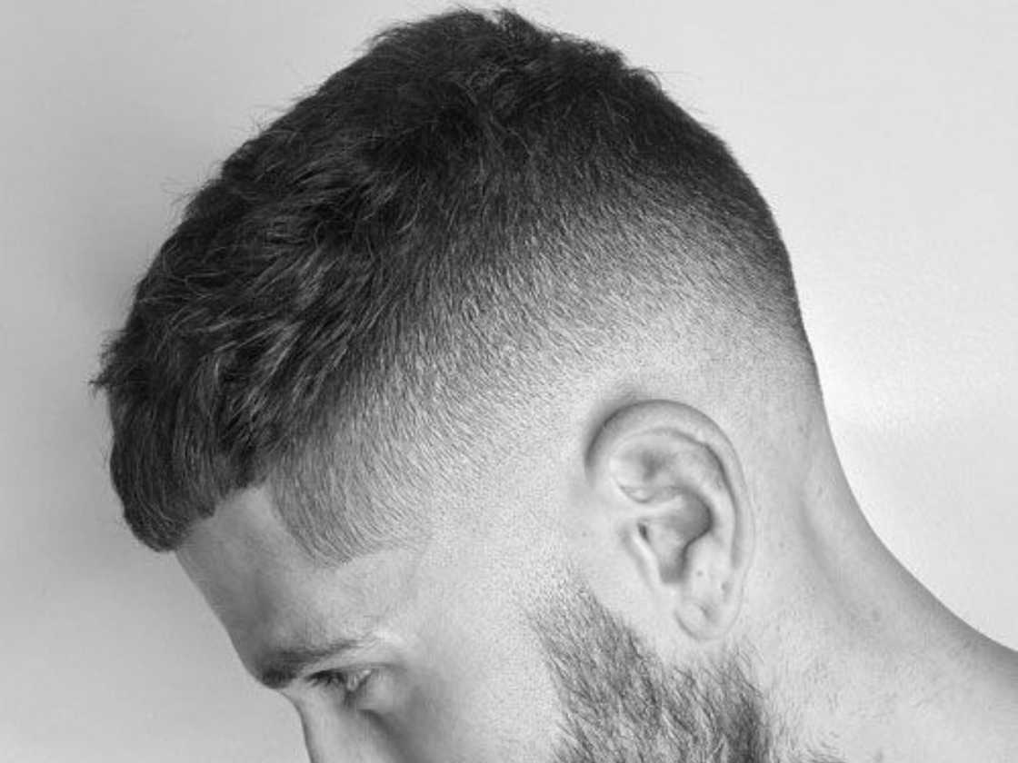 A man is showing off his new crew cut haircut A man is showing off his new crew cut haircut