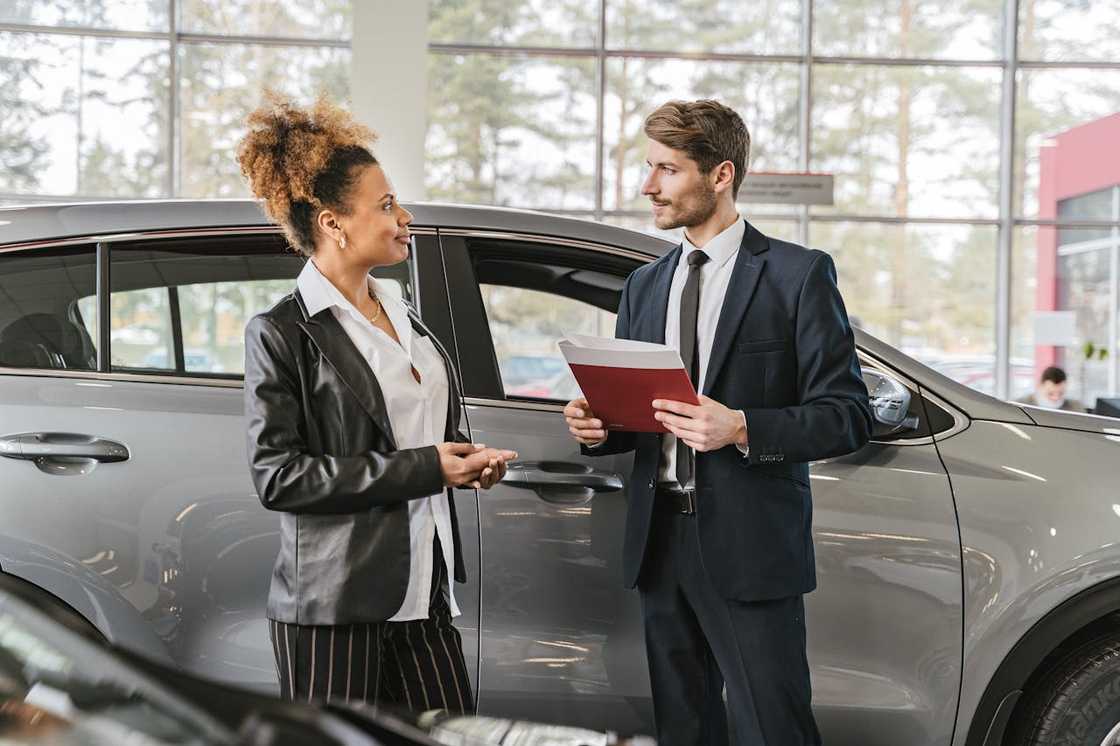 Woman stepping back from a vehicle, exhaling in relief after a successful inspection. Woman stepping back from a vehicle, exhaling in relief after a successful inspection.