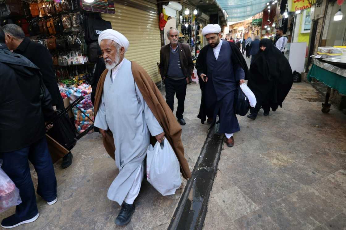 Across Iran, the economic pain has fuelled political malaise, with a poll finding many don't intend to vote Across Iran, the economic pain has fuelled political malaise, with a poll finding many don't intend to vote