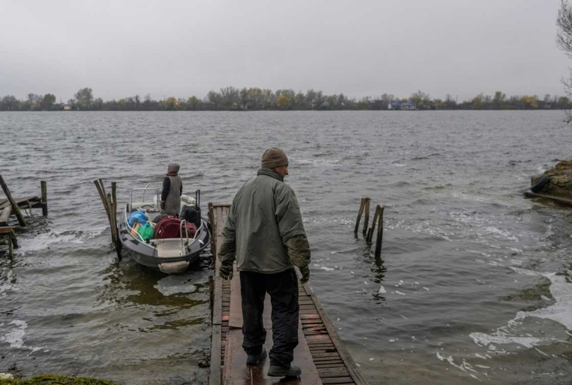 A man and his wife leave their home for their summer residence near the Dnipro River after an attack on an oil depot in Kherson A man and his wife leave their home for their summer residence near the Dnipro River after an attack on an oil depot in Kherson