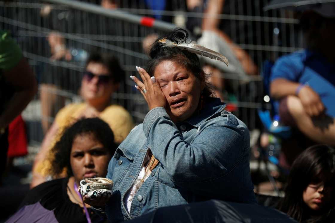 An Indigenous woman cries as Catholic faithful listen to Pope Francis celebrate mass inside the shrine of Sainte-Anne-de-Beaupre in Quebec, Canada, on July 28, 2022 An Indigenous woman cries as Catholic faithful listen to Pope Francis celebrate mass inside the shrine of Sainte-Anne-de-Beaupre in Quebec, Canada, on July 28, 2022