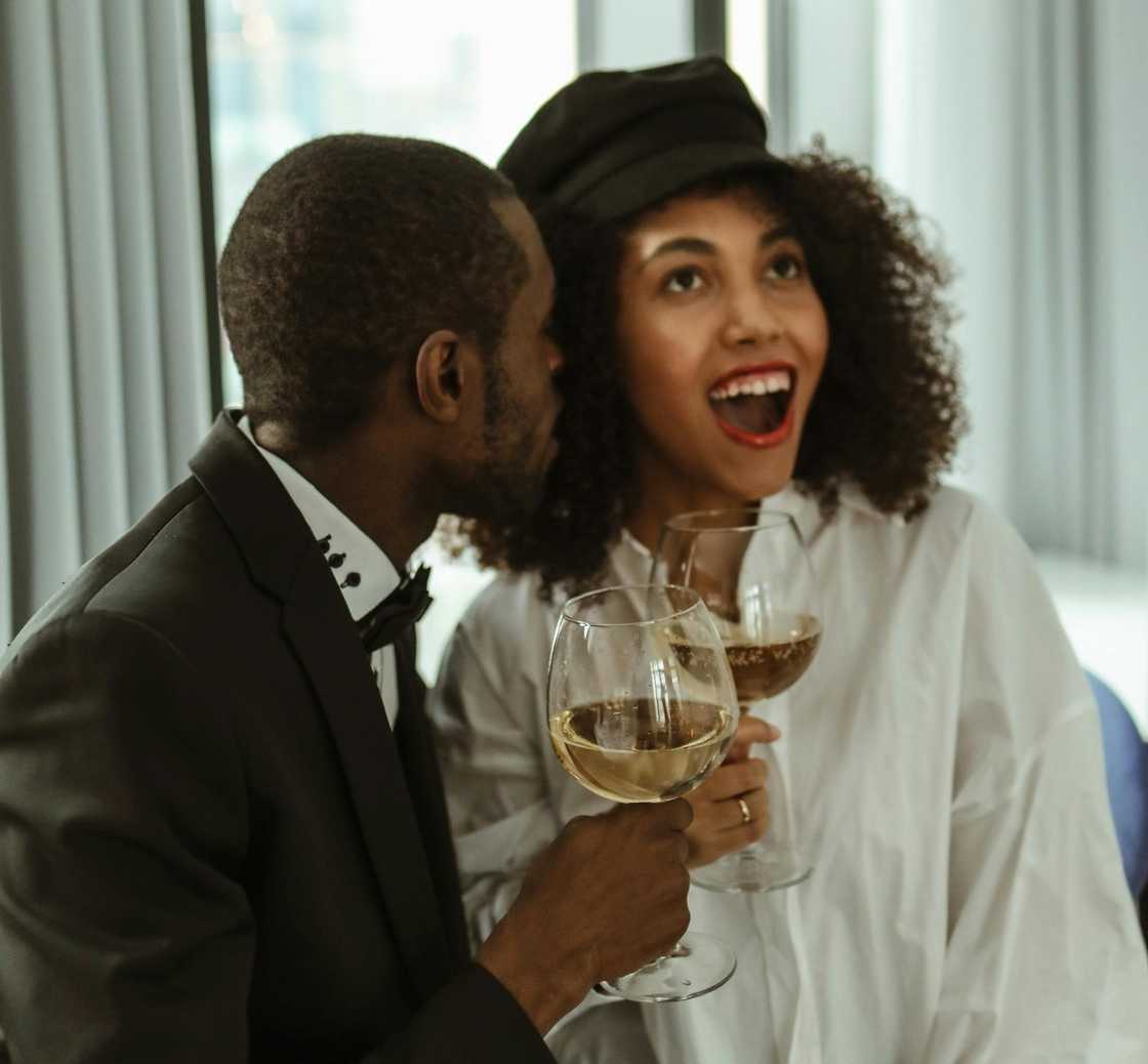 A man whispering to his wife