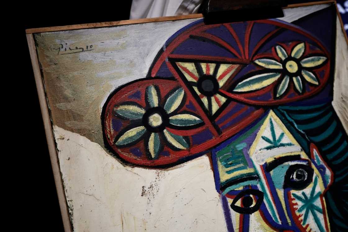 The painting is in a simple wooden frame