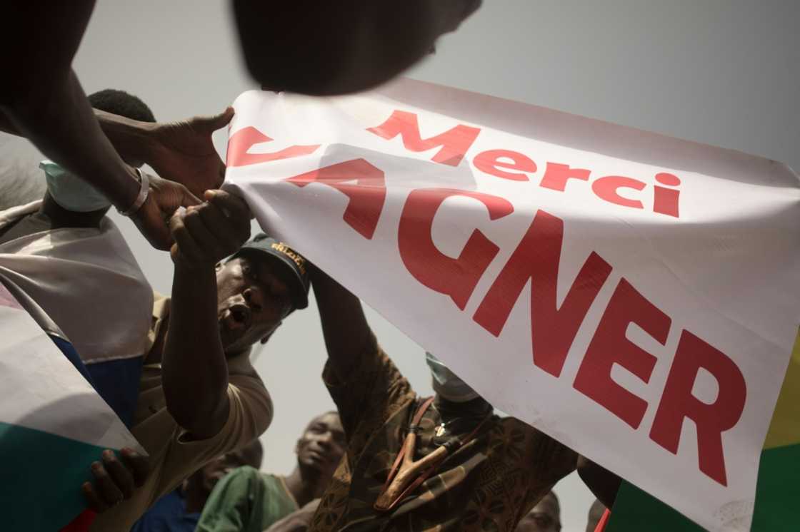 Protesters hold a banner reading 'Thank you Wagner', the name of the Russian private security firm present in Mali Protesters hold a banner reading 'Thank you Wagner', the name of the Russian private security firm present in Mali