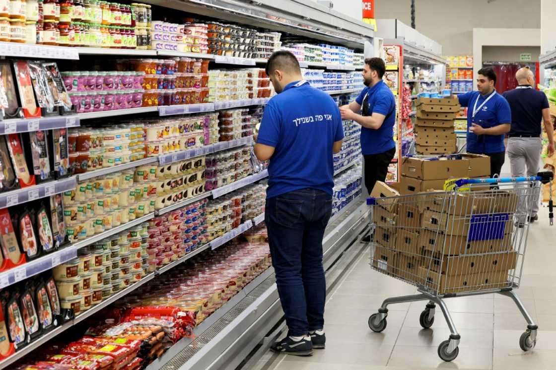 Employees of the Carrefour Hypermarket in Raanana, Israel, stock shelves before the French firm's opening in the country Employees of the Carrefour Hypermarket in Raanana, Israel, stock shelves before the French firm's opening in the country
