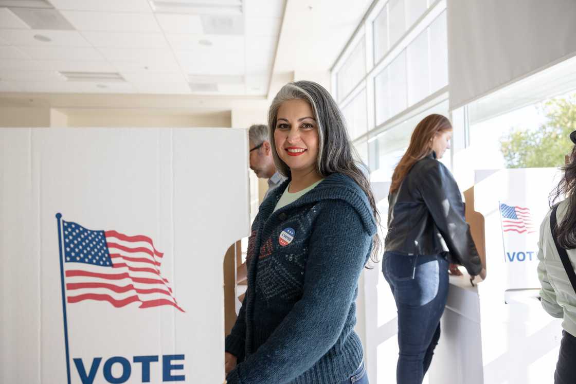 A woman casts her vote at a local community centre. A woman casts her vote at a local community centre.