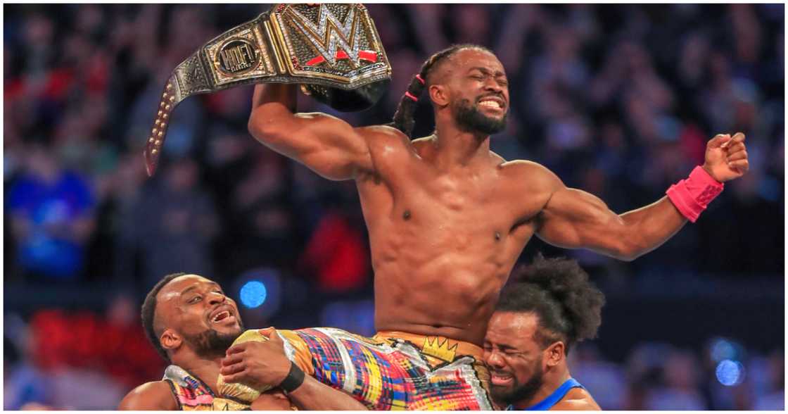 Kofi Kingston is lifted by fellow wrestlers after winning WrestleMania 35